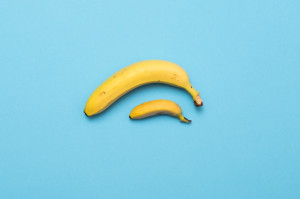 small-banana-compare-size-with-banana-on-blue-royalty-free-image-1576796250